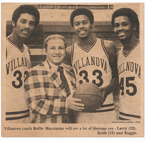 Villanova coach Rollie Massimino posing with Larry Herron (#32), Keith Herron (#33), and Reggie Herron in Villanova uniforms